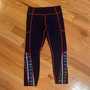Tuckernuck Sport navy blue leggings with red stitching and tie dye pattern